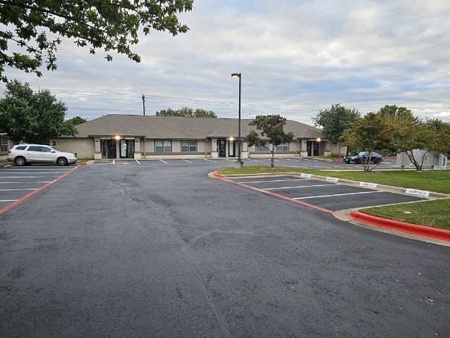 Services Parking lot photo showing lot with new sealcoating and fresh striping
